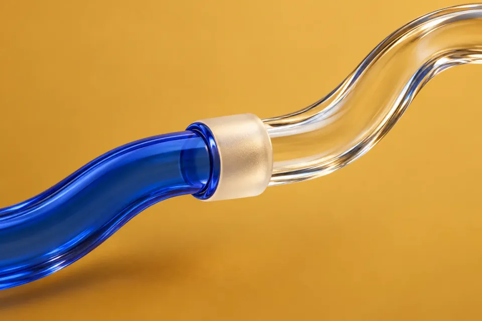 Editorial illustration: A curved glass conduit changes from cobalt blue to clear at a pale coupling.